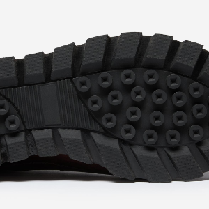 Closeup of Cleated rubber outsole with EVA midsole
