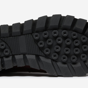 Closeup of Cleated rubber outsole with EVA midsole