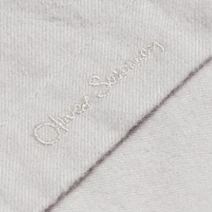 Closeup of Embroidered branding on placket