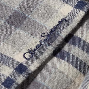 Closeup of Embroidered branding on placket