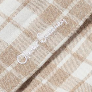 Closeup of Embroidered branding on placket